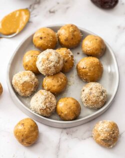 A batch of peanut butter bliss balls on a small dish.