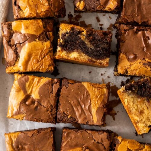 Top down view of brownie blondies on a sheet of baking paper.