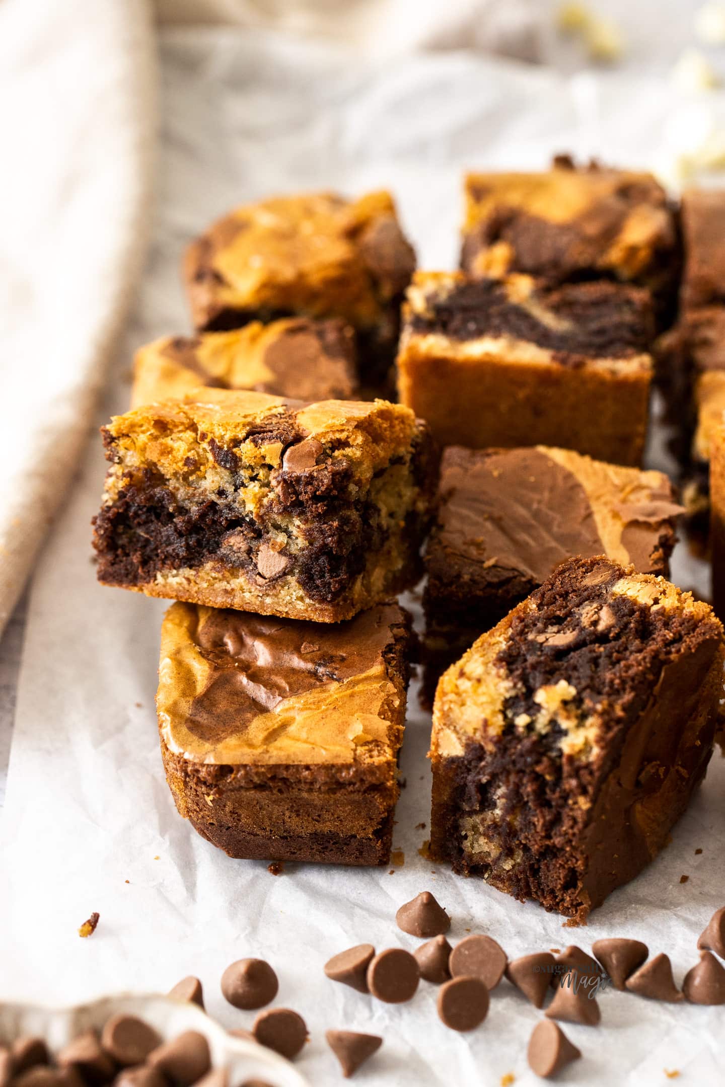 A batch of brownie blondies surrounded by chocolate chips.