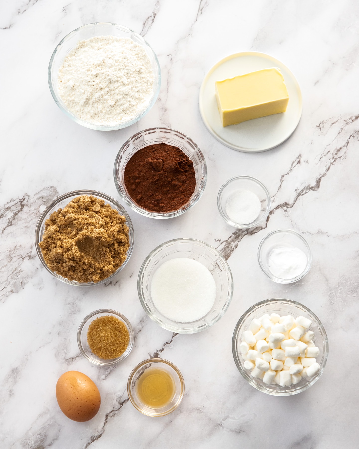 Ingredients for Chocolate Marshmallow cookies on a marble surface.