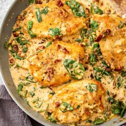 4 pieces of chicken in a creamy sauce in a large skillet.