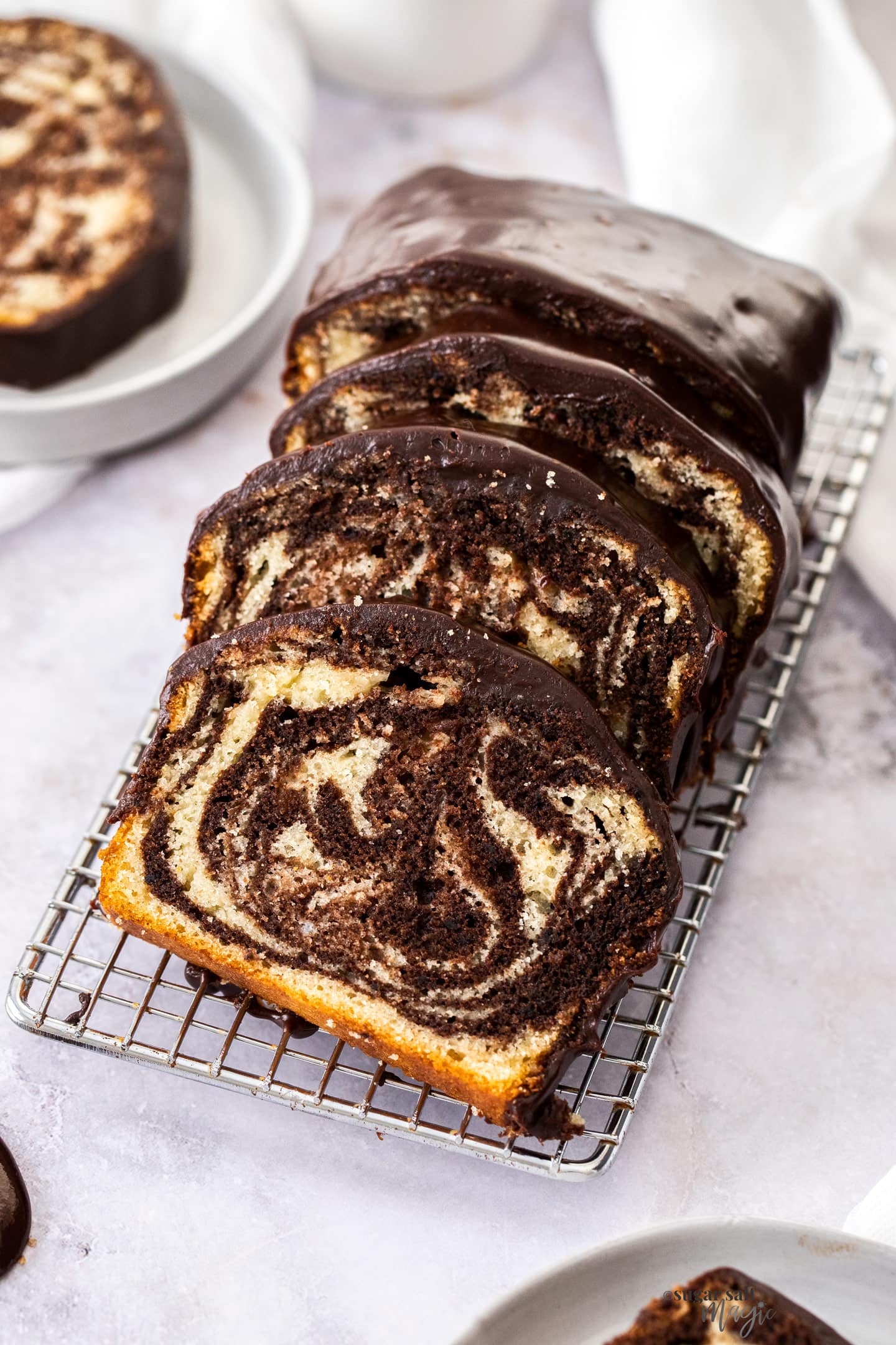 Slices of marble cake on a wire rack.