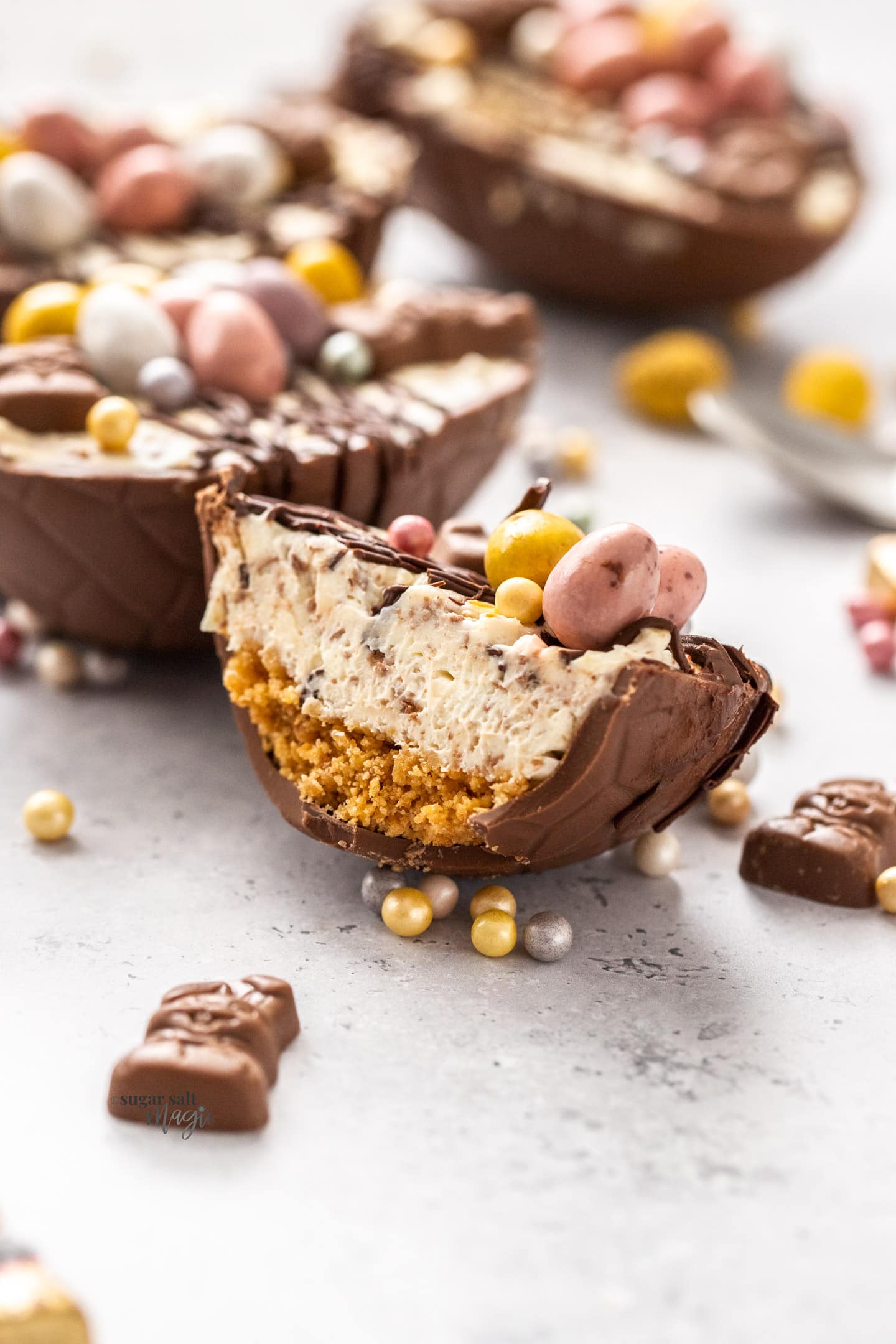An Easter egg cheesecake cut in half to show the inside.