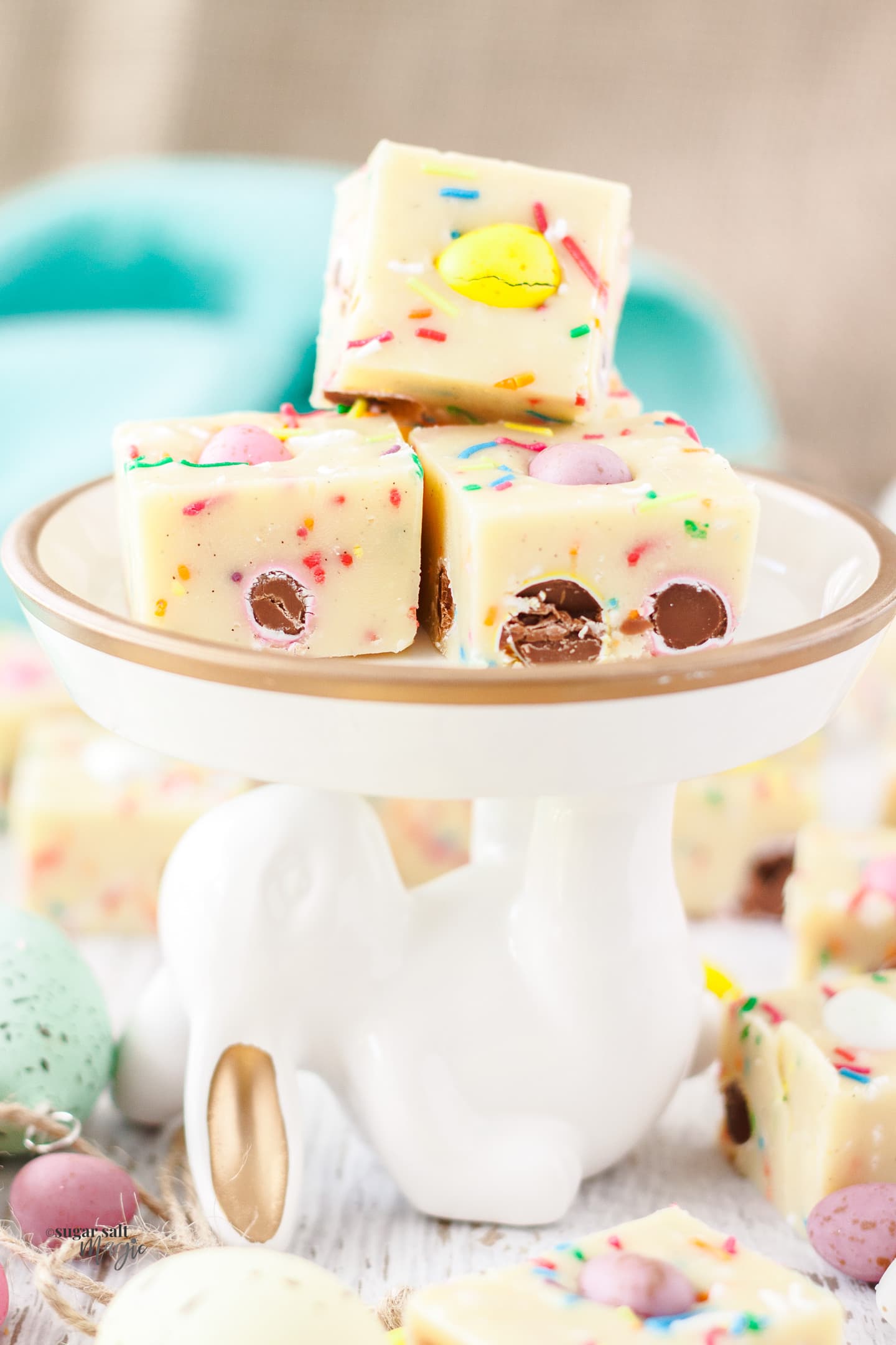 3 pieces of mini eggs fudge on top of a bunny shaped plate.