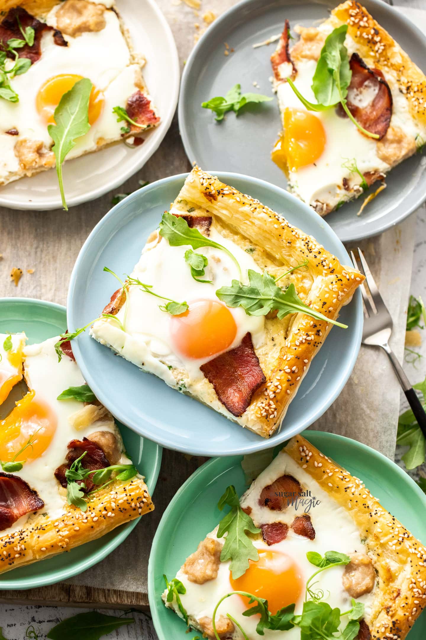 Top down view of slices of breakfast tart on colourful plates.