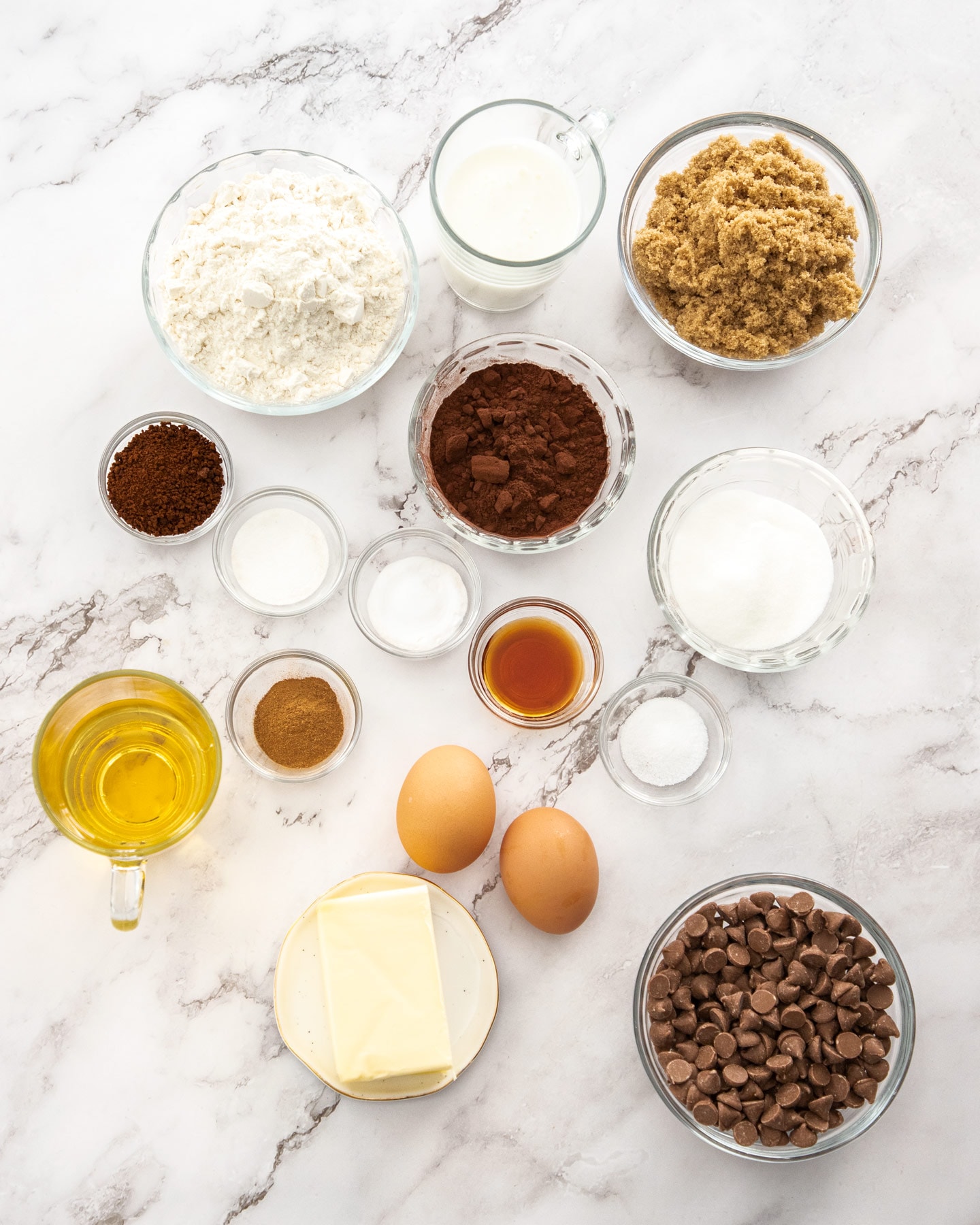 Ingredients for chocolate crumb cake on a marble bench top.