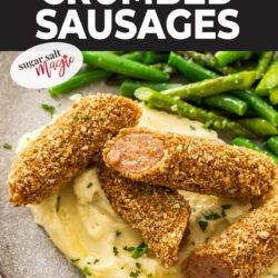 Crumbed sausages cut into pieces on a pile of mashed potato.