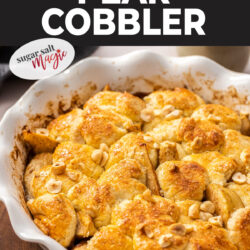 A white pie dish filled with baked pear cobbler.