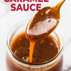 A spoon coated with caramel sauce, hovering over a jar.