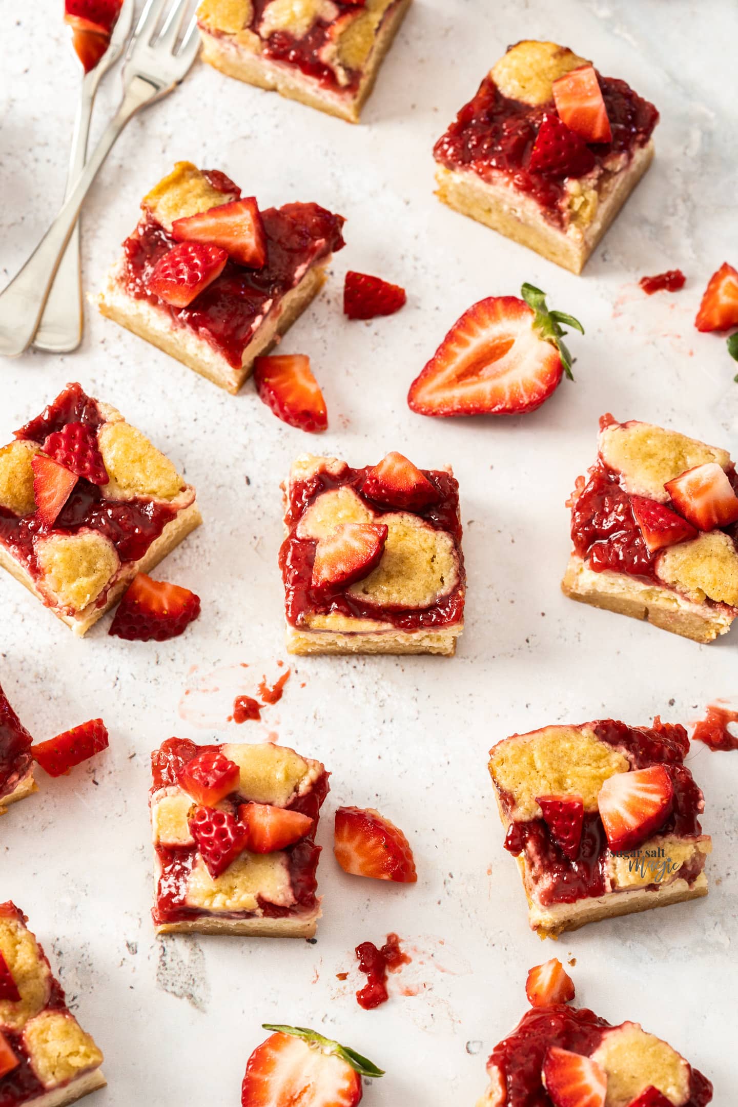 Top down view of squares of strawberry cheesecake bars.