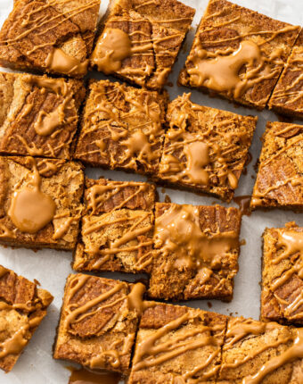 Top down view of a batch of Biscoff blondies, dolloped with Biscoff spread.