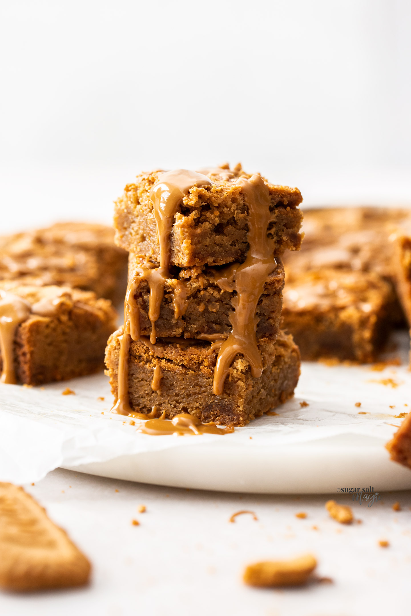 A stack of 3 Biscoff blondies with Biscoff spread oozing down the side.