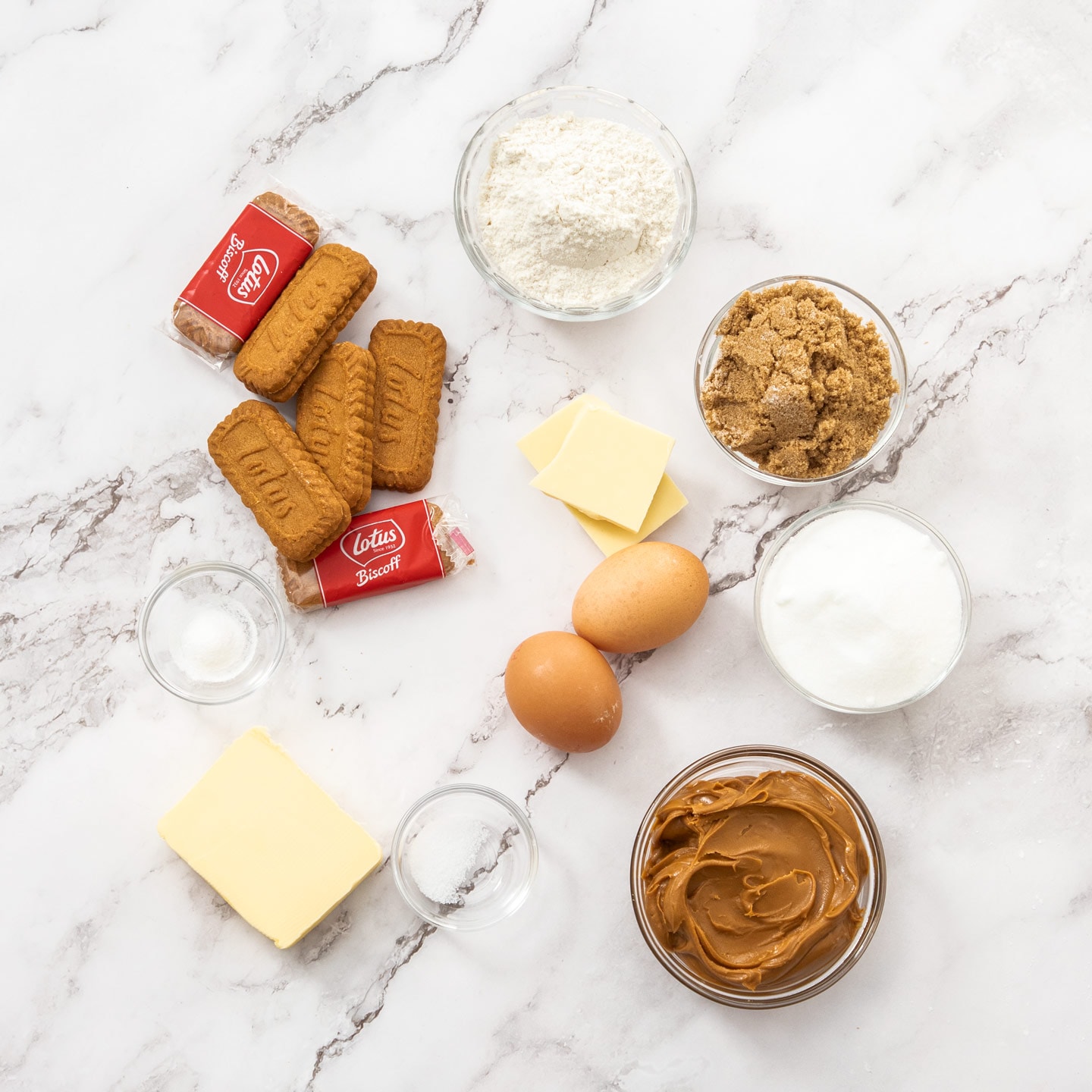 Ingredients for Biscoff blondies on a marble surface.