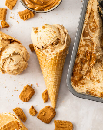 A waffle cone filled with scoops of Biscoff ice cream.