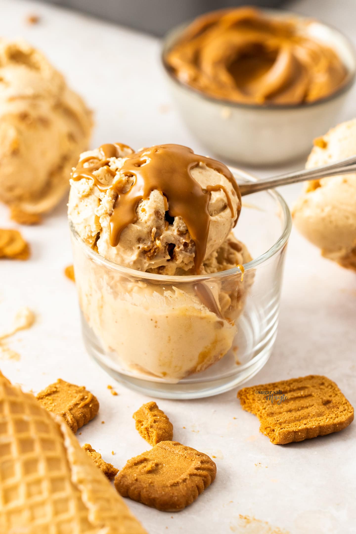 A small glass pot filled with scoops of Biscoff ice cream.