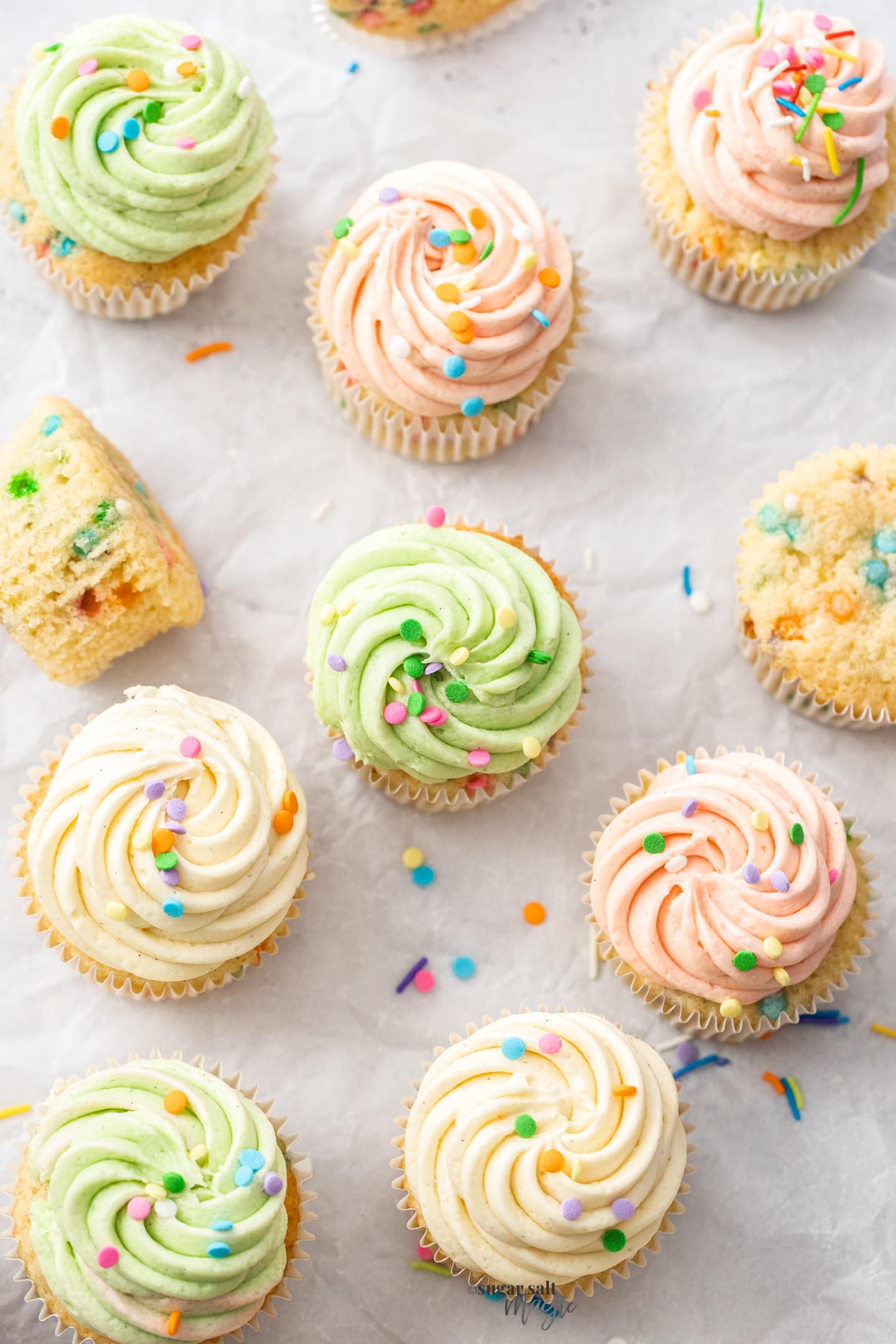 Top down view of a batch of confetti cupcakes.