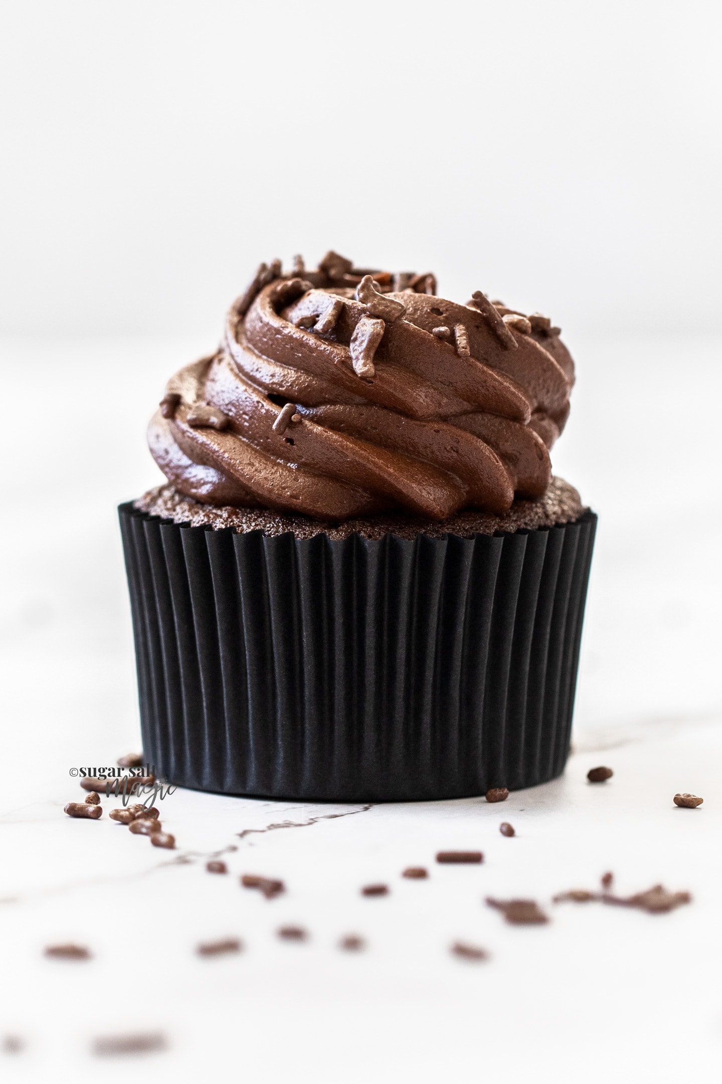 A closeup of a single chocolate cupcake.