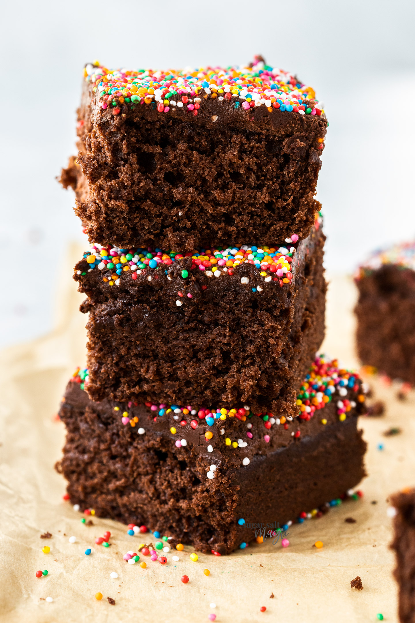 A stack of 3 pieces of chocolate cake.