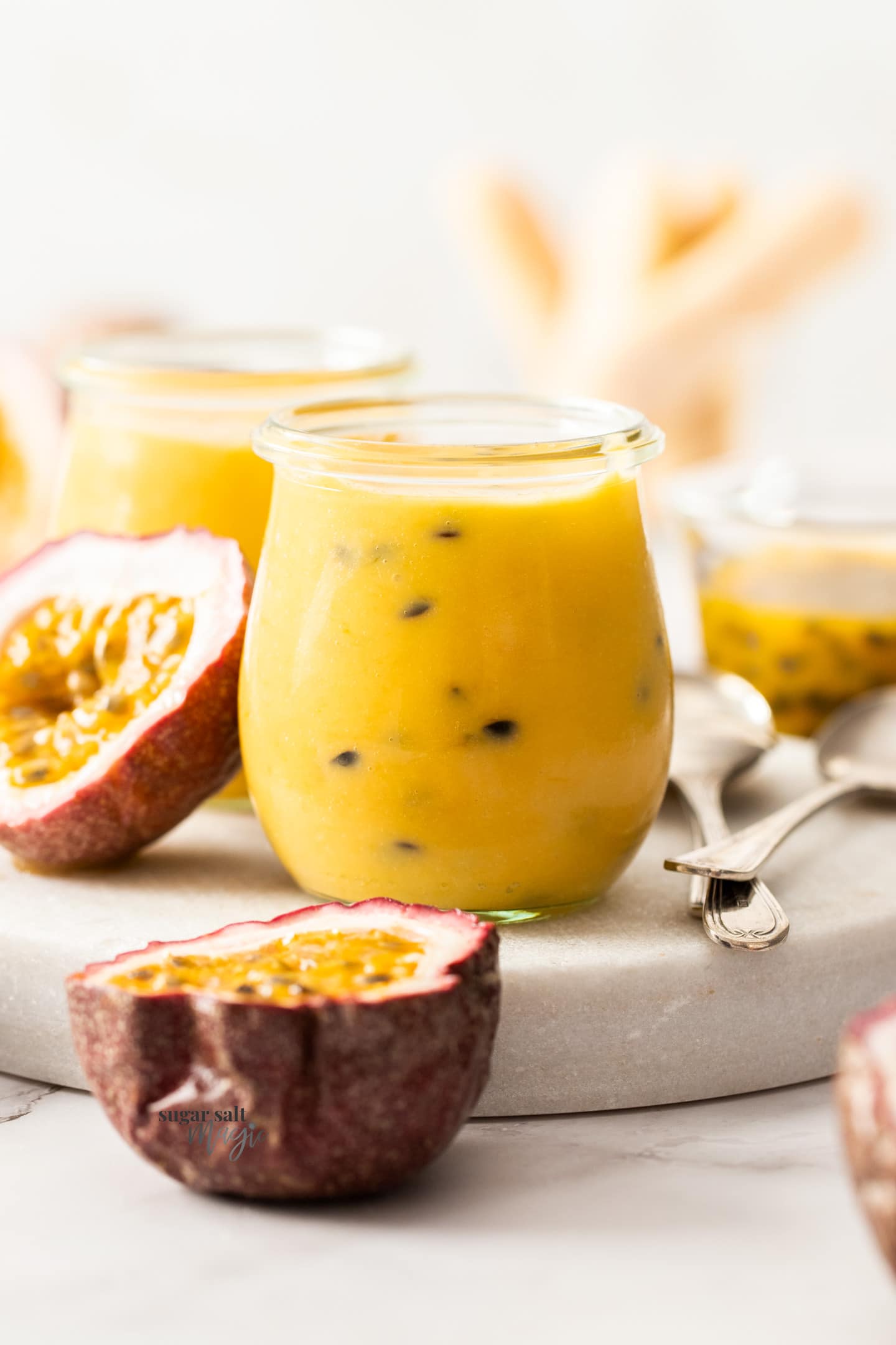 A small jar filled with passionfruit curd.