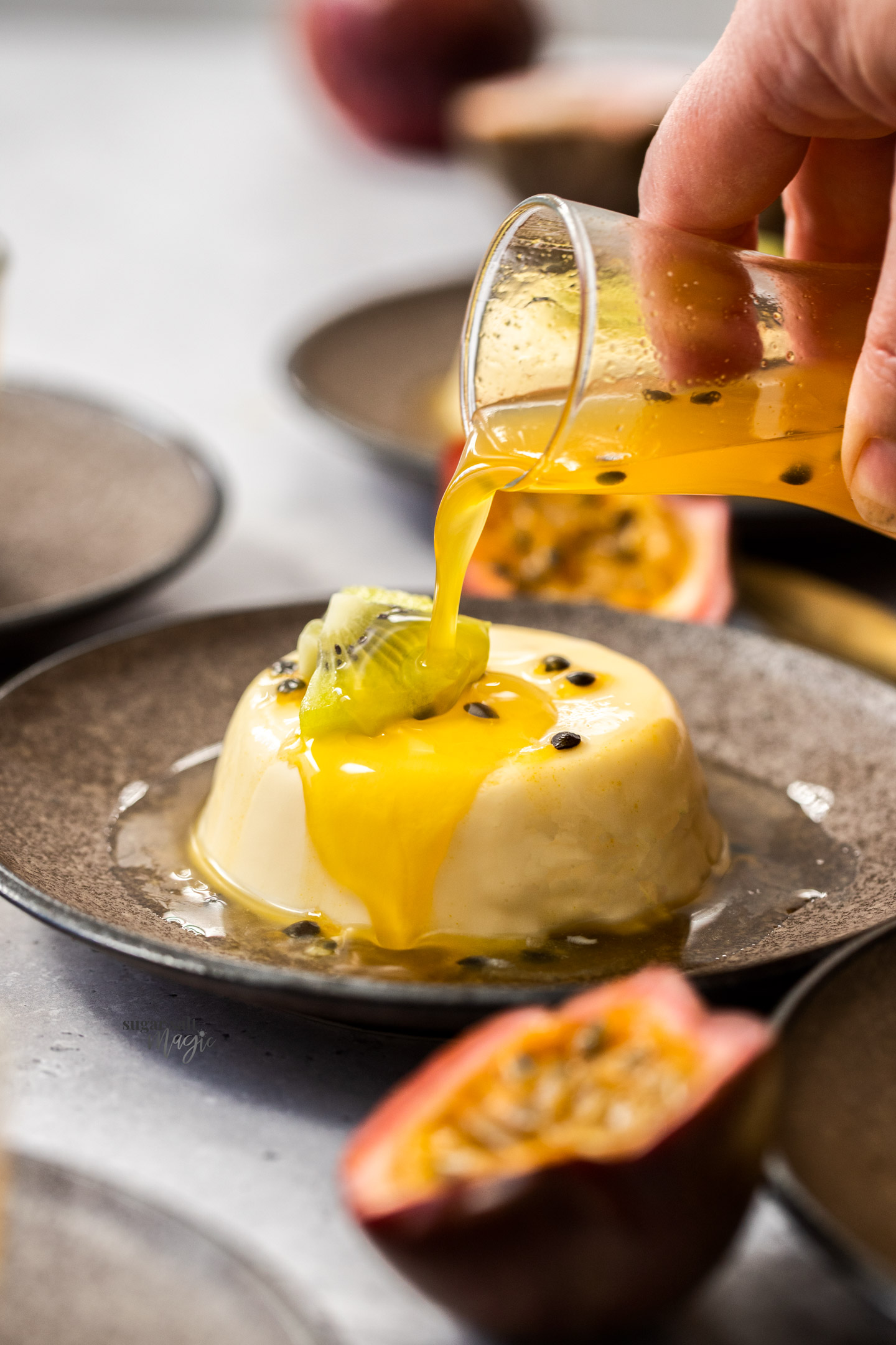 Syrup being poured over panna cotta.