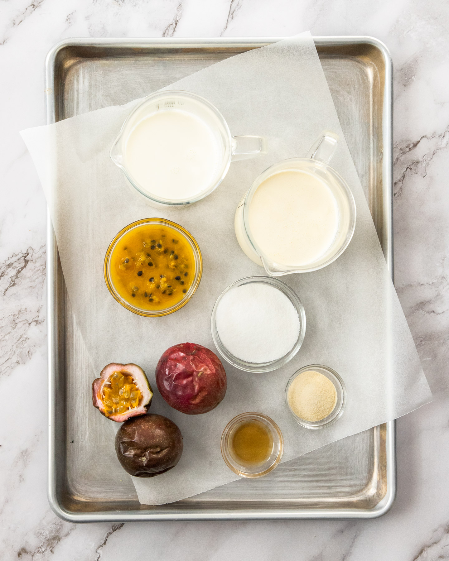 Ingredients for passionfruit panna cotta on a baking tray.