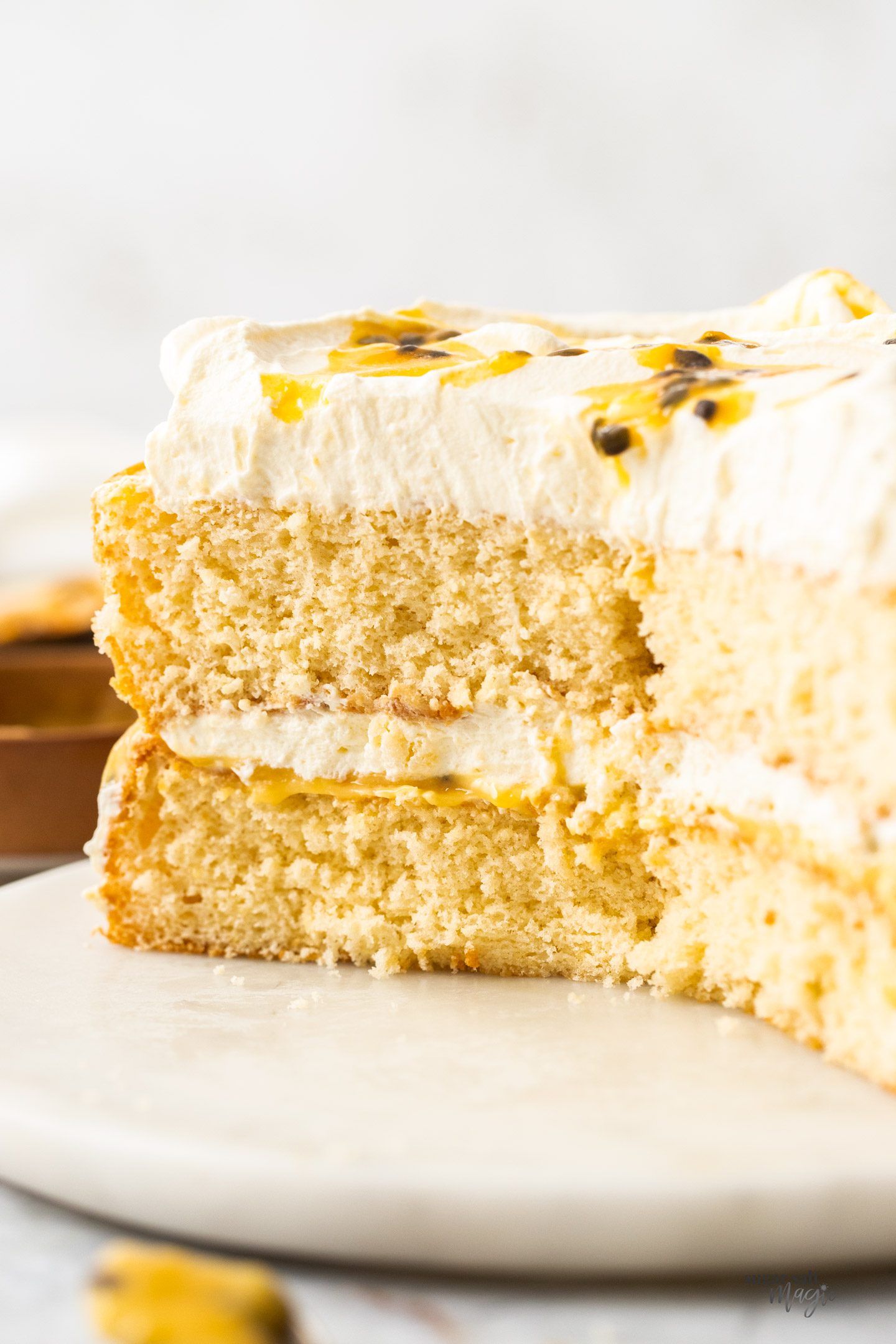 A passionfruit sponge cake, cut open to show the inside texture.