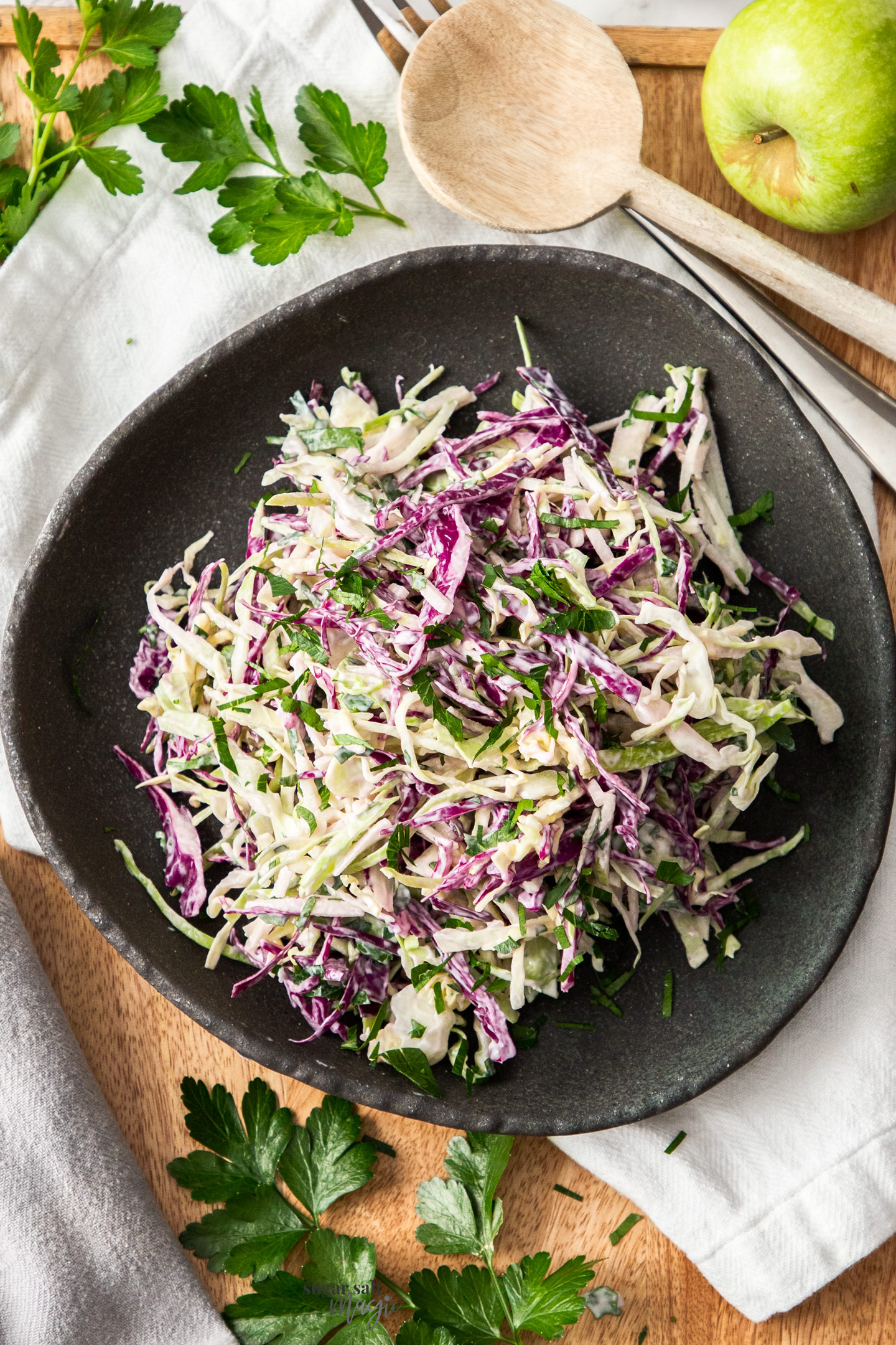 Top down view of apple slaw in a serving bowl.
