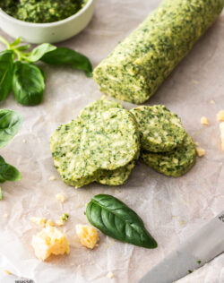 Disks of pesto butter on a sheet of baking paper.