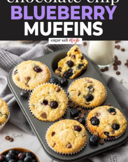 A 6 hole muffin tin with baked blueberry muffins in it.