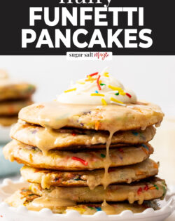 A stack of funfetti pancakes with cream on top and glaze.