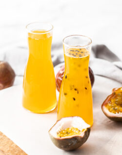 Two bottles filled with passionfruit syrup.