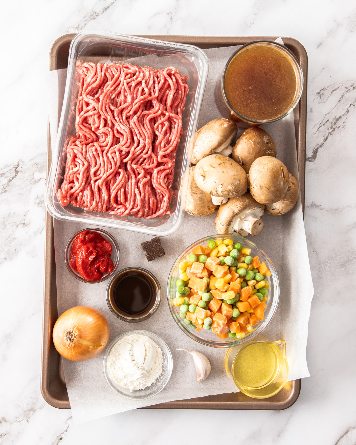 Ingredients for savoury mince on a baking tray.