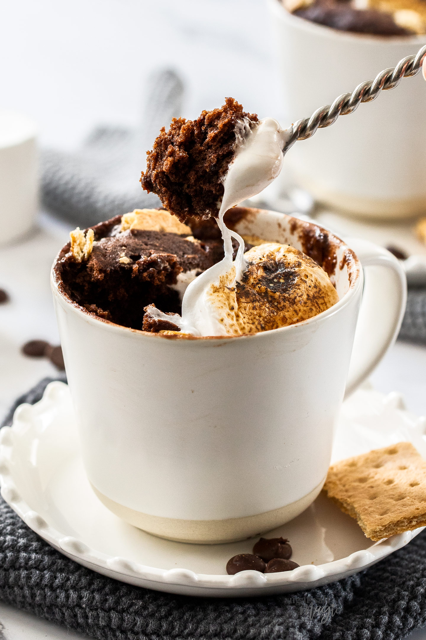 A spoonful of chocolate mug cake being scooped out of a mug.