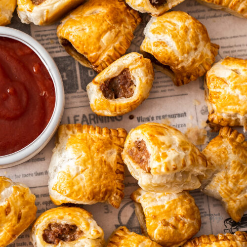 Top down view of a batch of sausage rolls.
