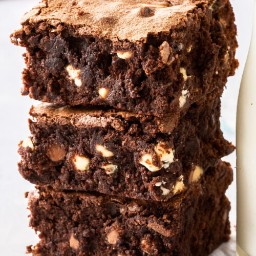 A stack of 3 chocolate chip brownies, closeup.