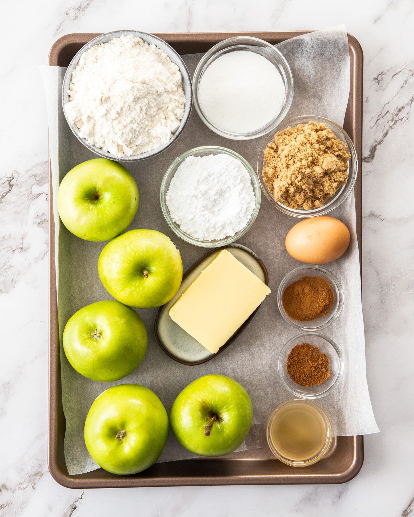 Ingredients for apple crumble tart of a baking tray.