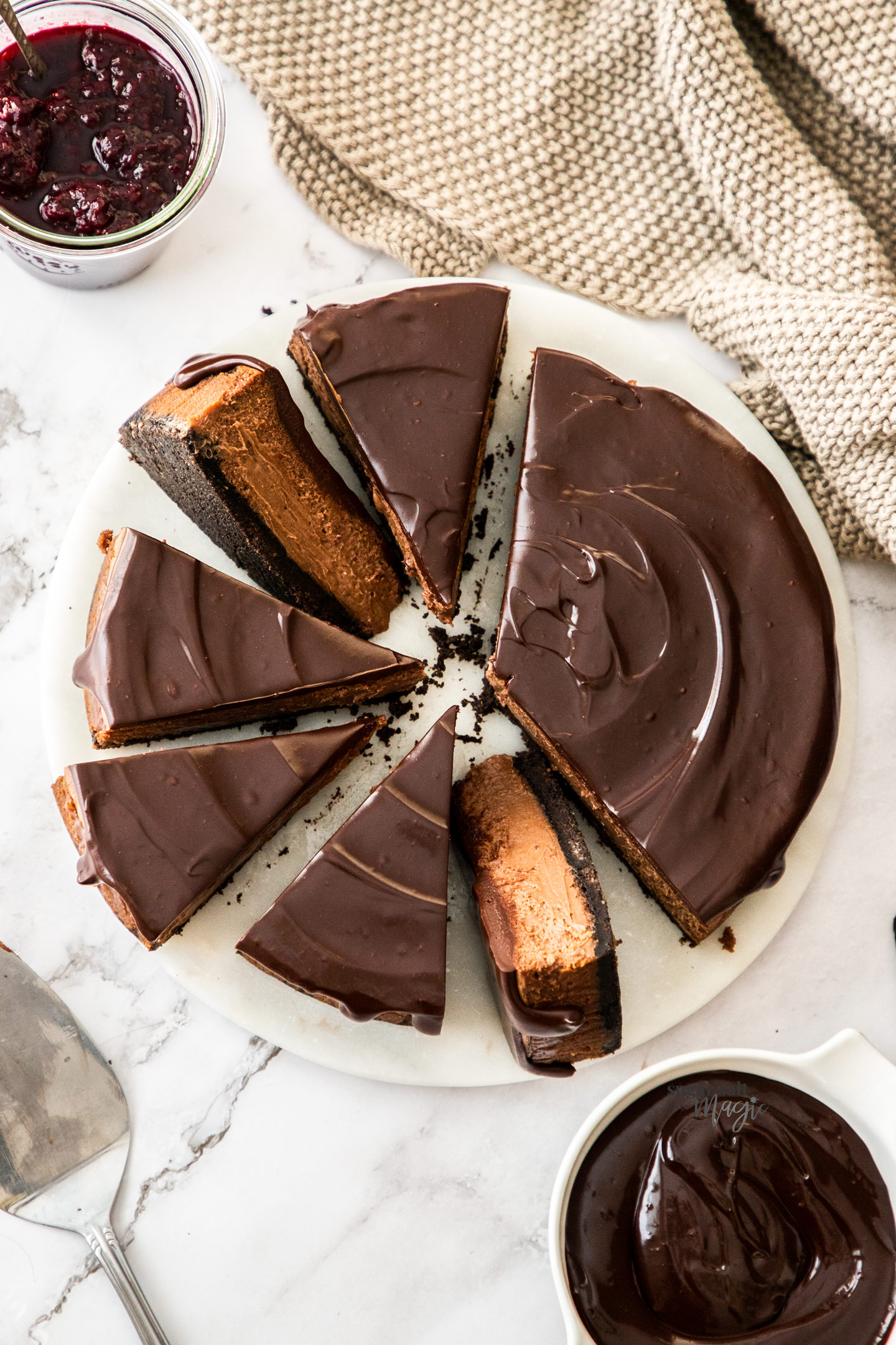 Top down view of a chocolate cheesecake cut into slices.