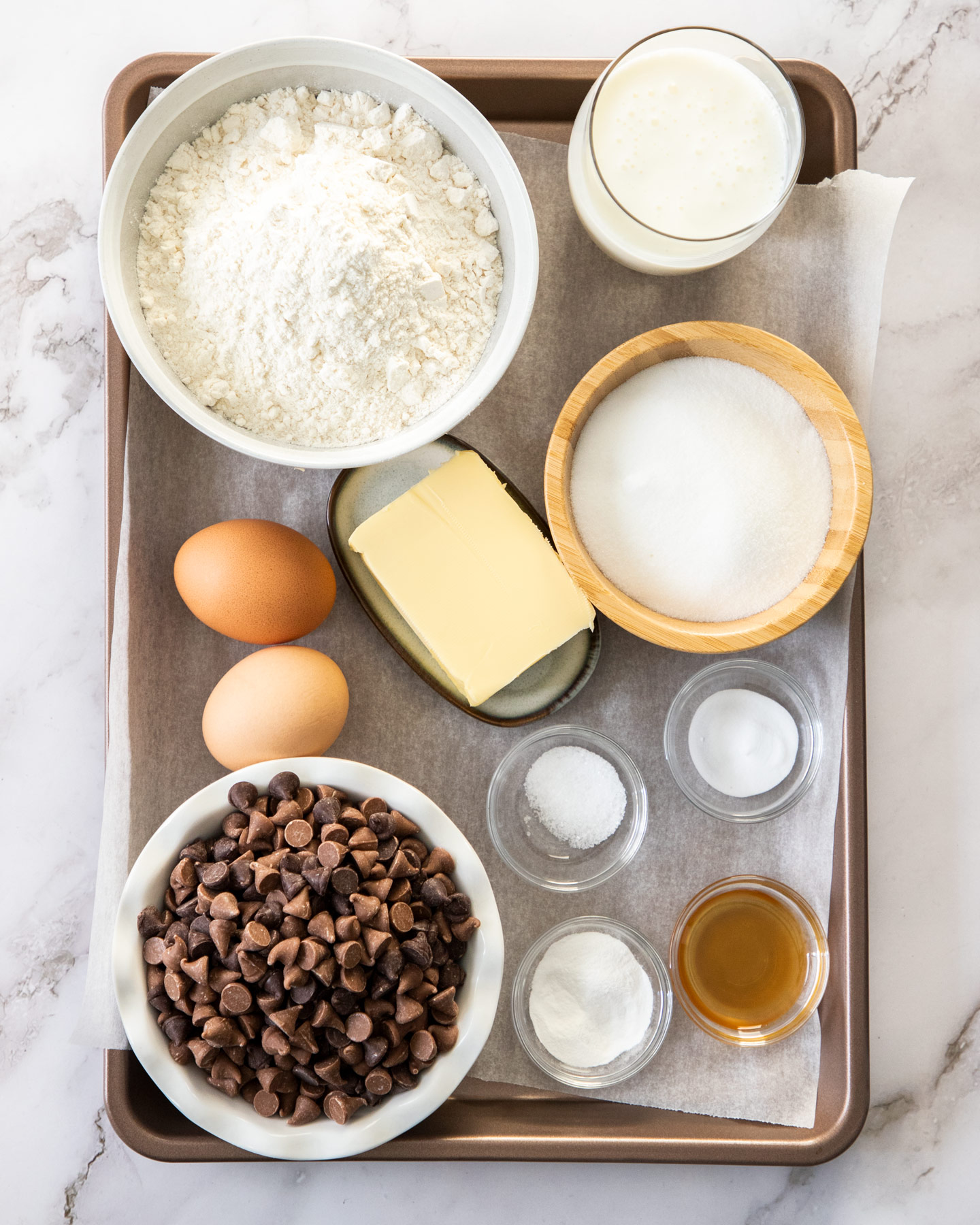 Ingredients for chocolate chip muffins in a baking tray.