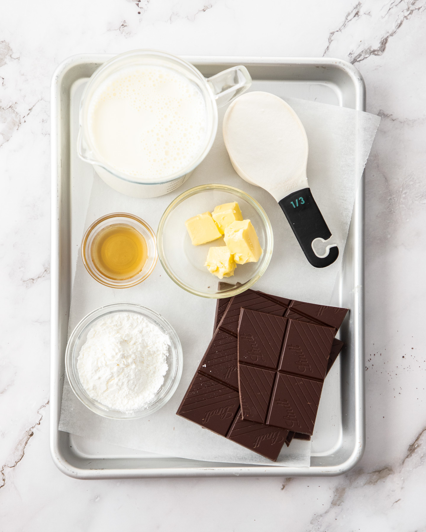 Ingredients for chocolate pots on a baking tray.