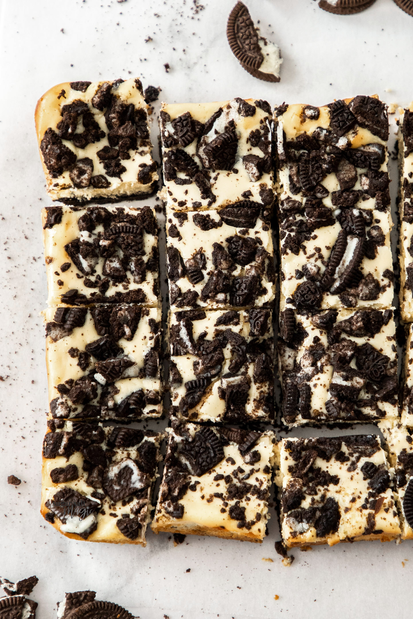 Top down view of 12 squares of Oreo cheesecake bars.