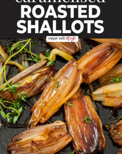 Close up of roasted shallots with sprigs of fresh thyme.