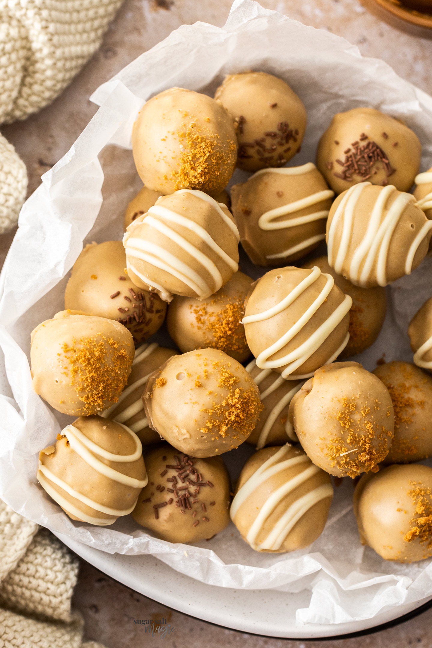 A batch of Biscoff truffles on a sheet of baking paper.