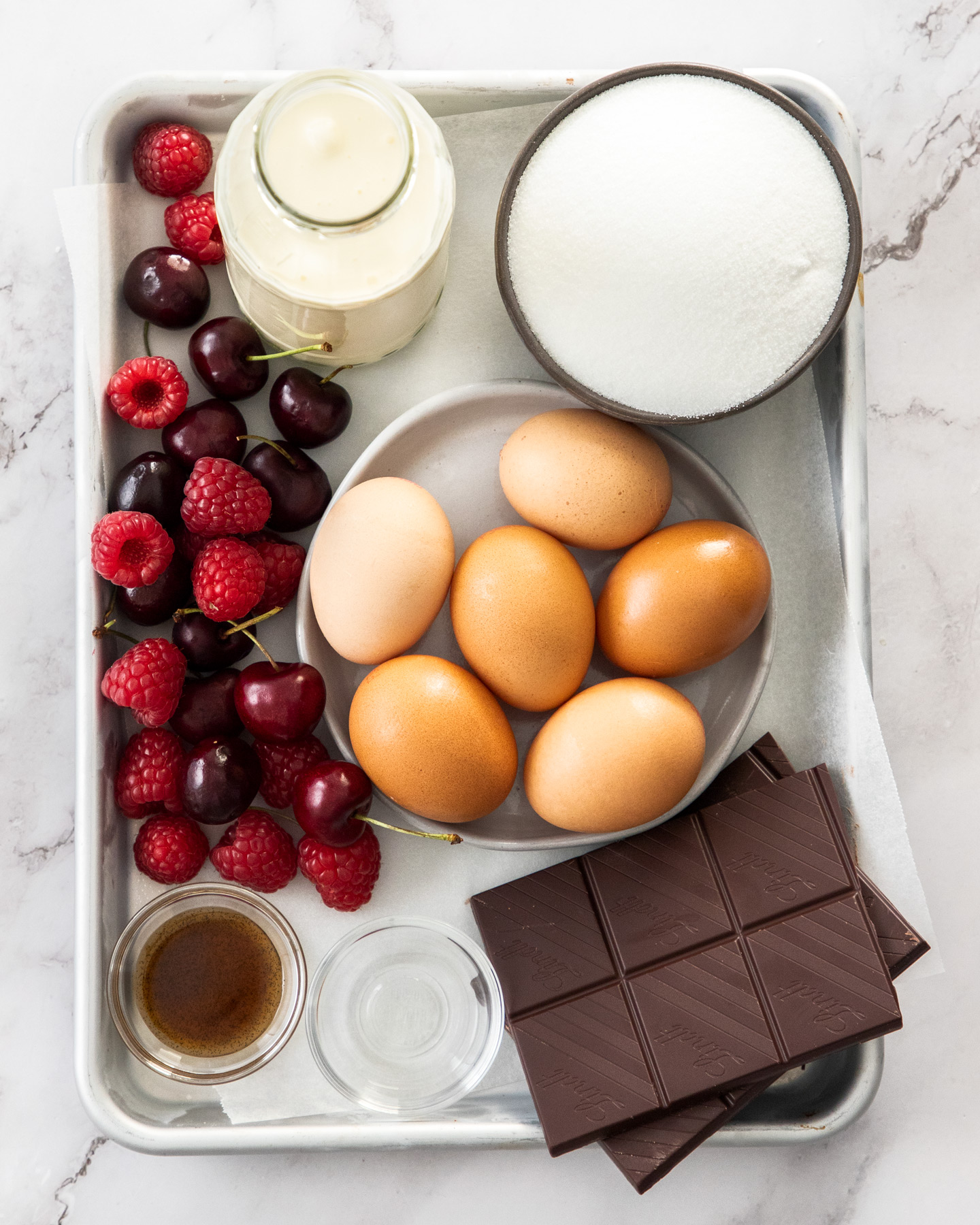 Ingredients for chocolate meringue cake on a baking tray.