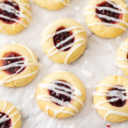 Closeup of 9 jam thumbprint cookies.