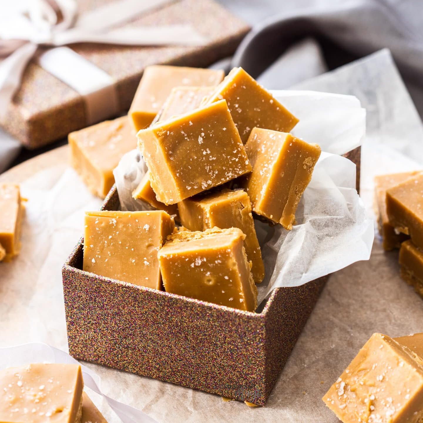 A gift box filled with squares of salted caramel fudge.