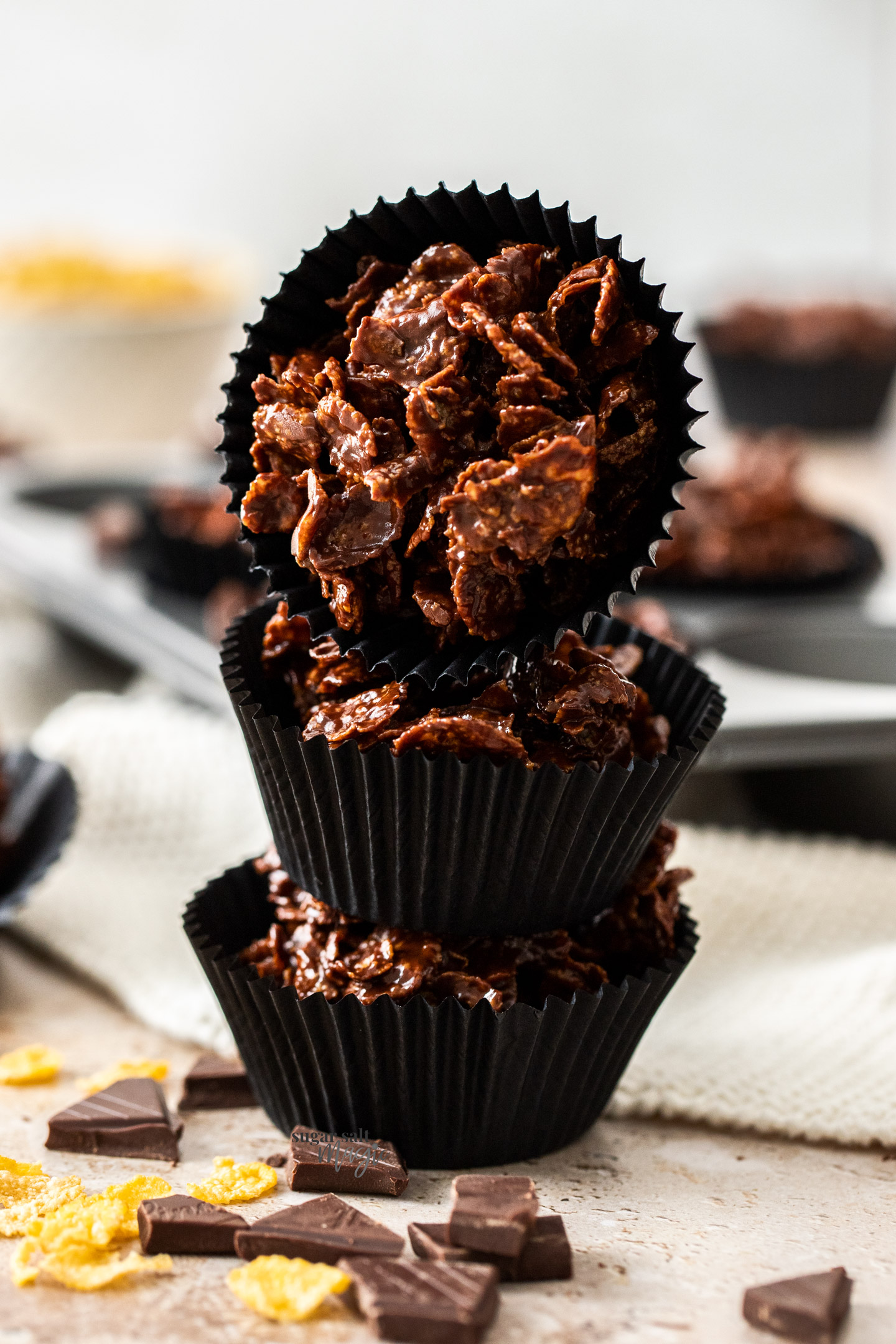 A stack of 3 chocolate cornflake cakes.