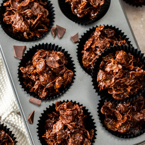 Top down view of chocolate cornflake cakes in a muffin tray.