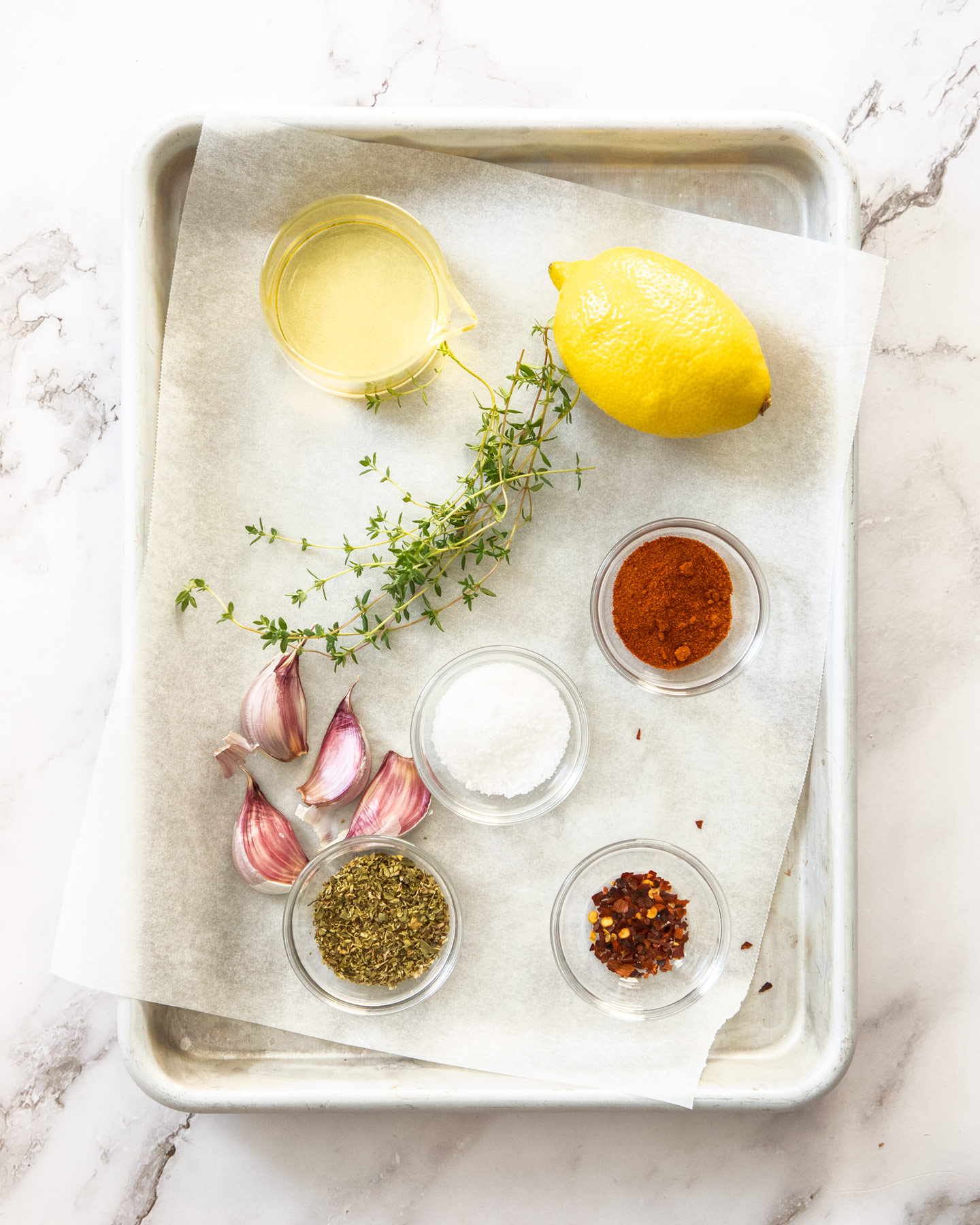 Ingredients for Greek marinade on a baking tray.