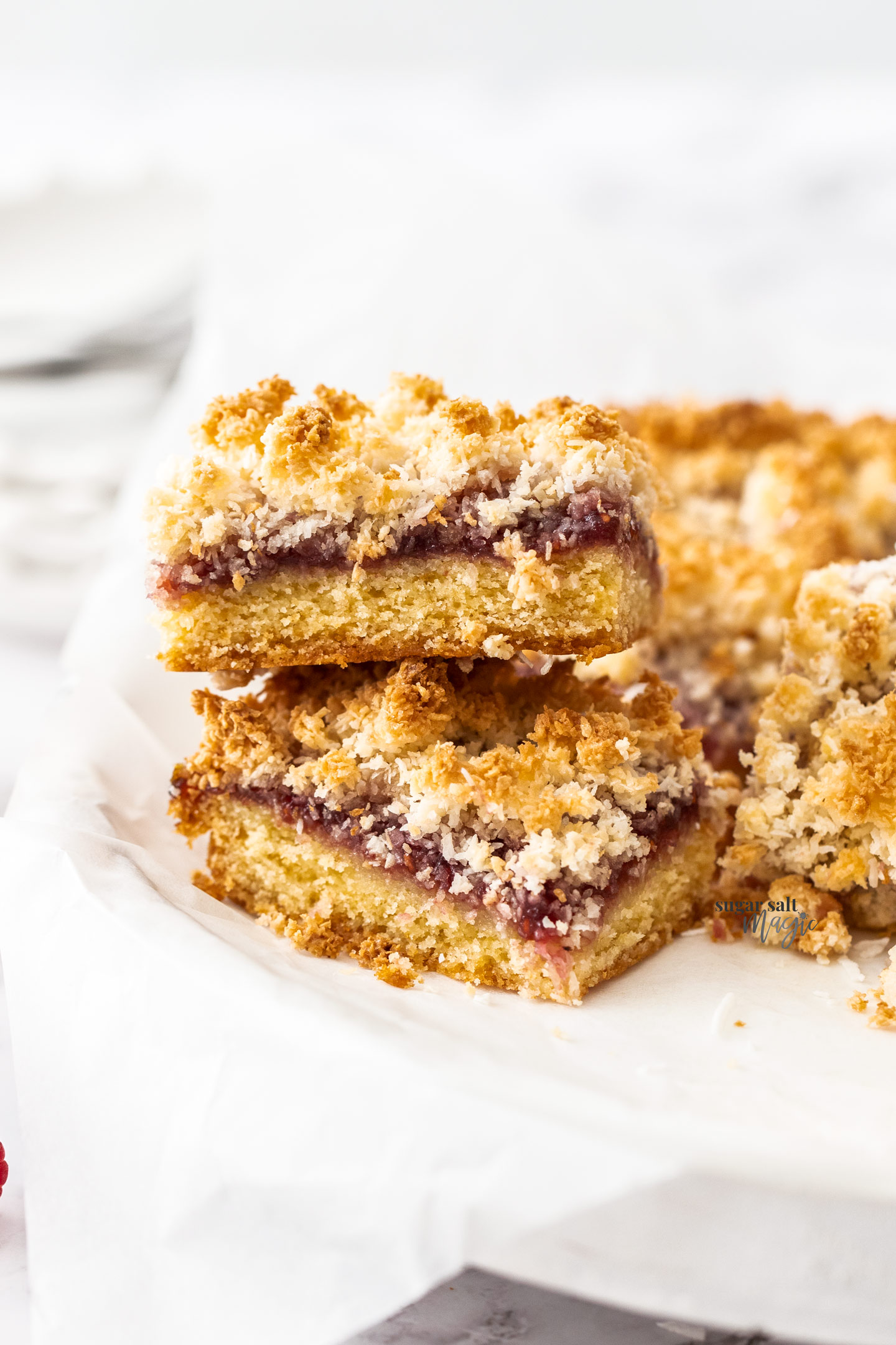 A stack of two pieces of raspberry coconut slice.