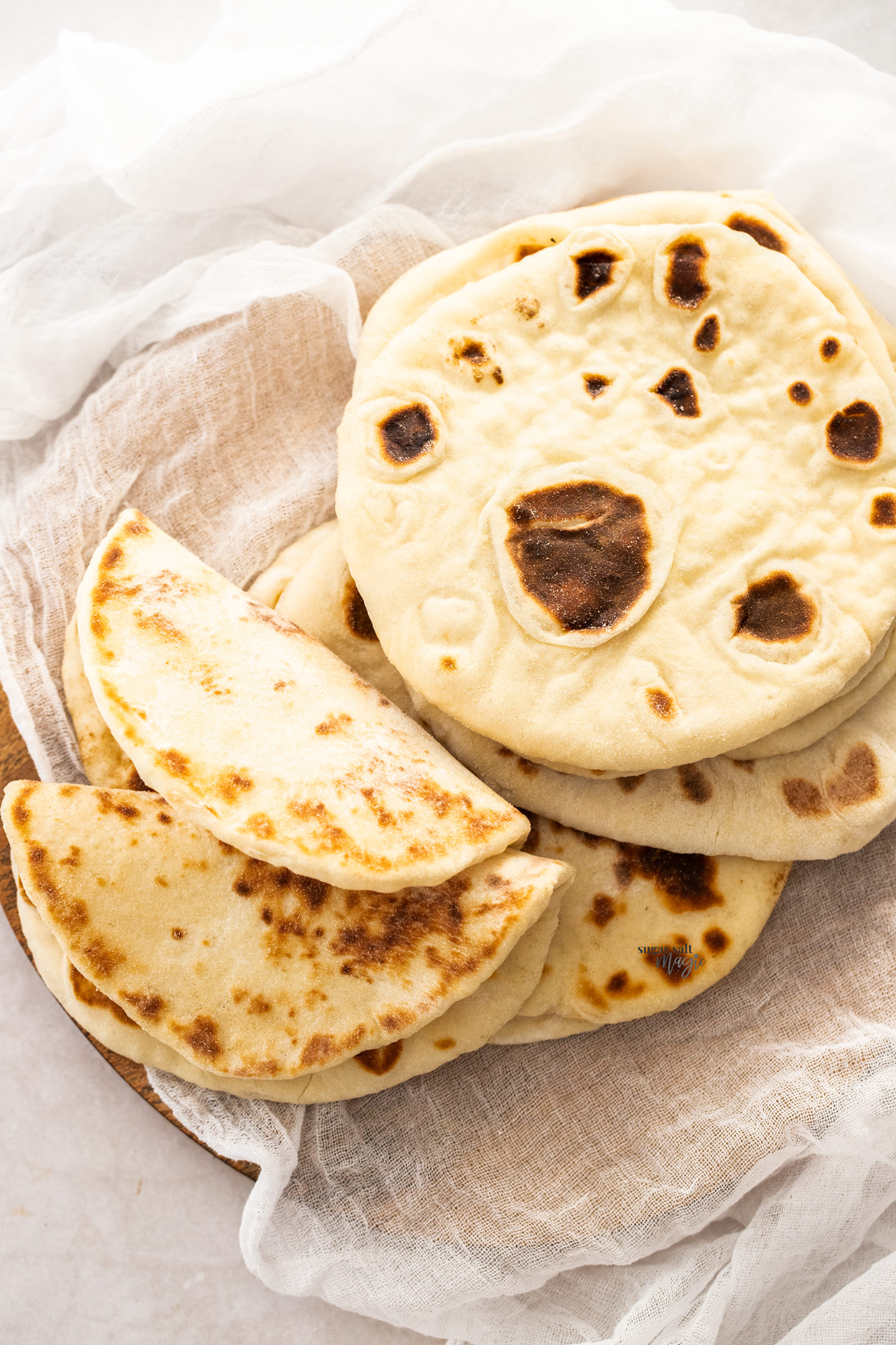 Top down view of flatbreads, some folded to show pliability.